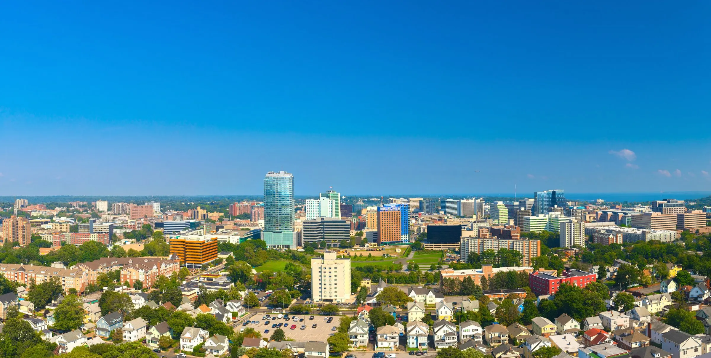 The downtown Stamford skyline seen from the west, above the rooftops of the West Side