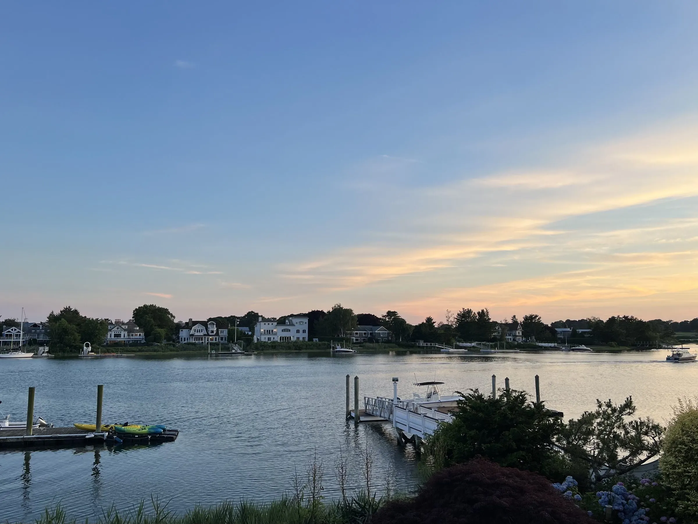 Smith Beach Harbor in Westport at sunset, with a dock in the foreground