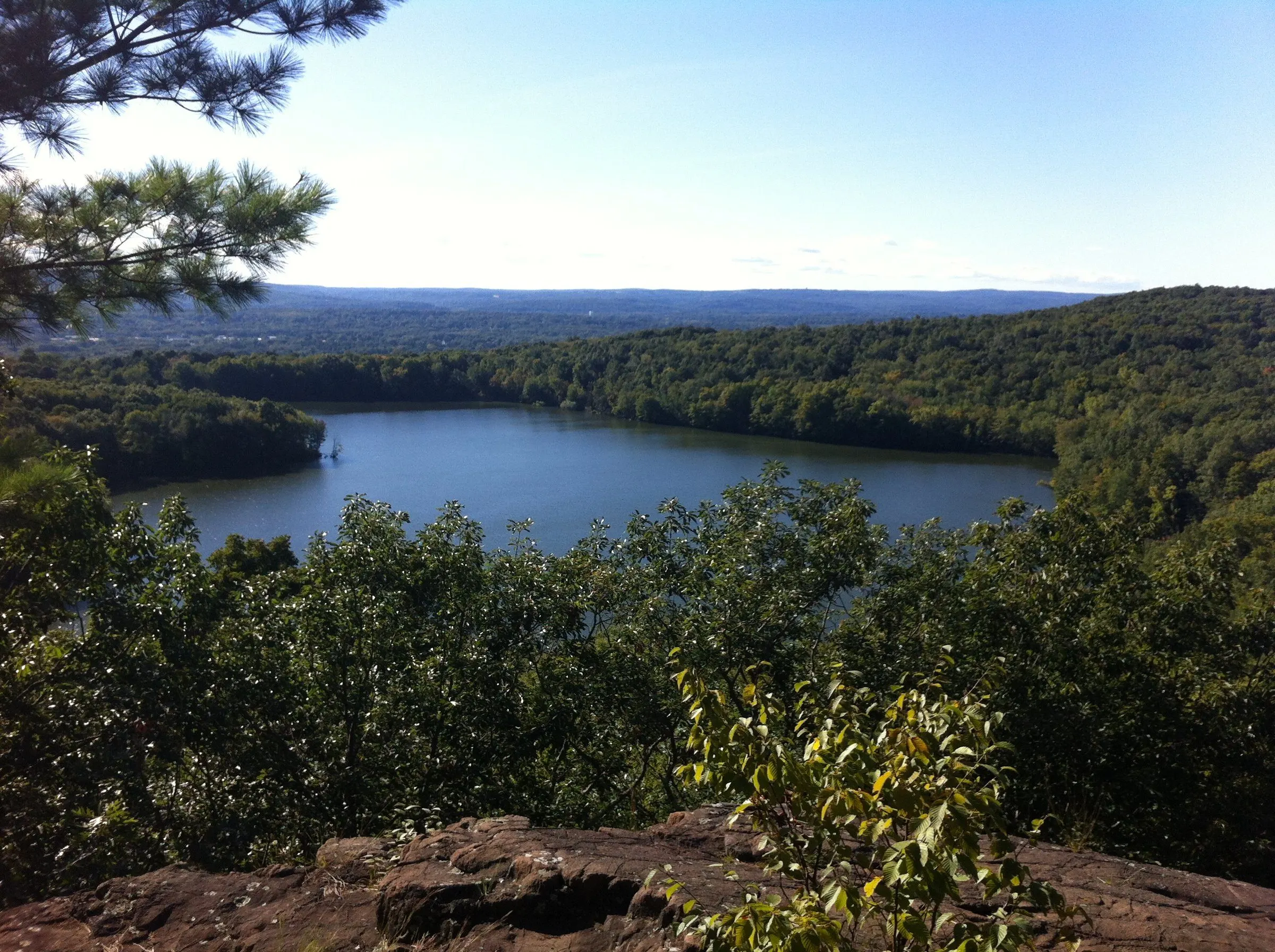 Crescent Lake seen from the ledges of Bradley Mountain, surrounded by wooded ridges