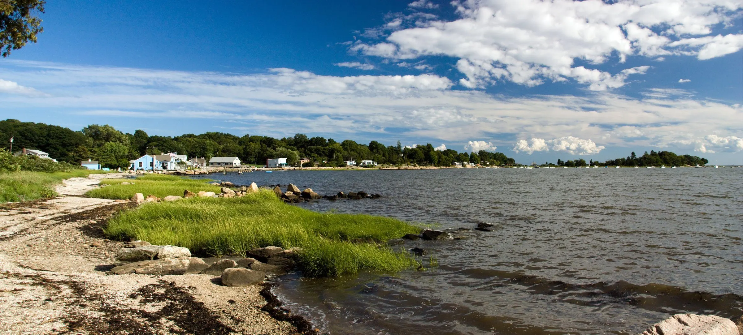 Shell Beach in Guilford on a summer day, with marsh grass, the shoreline and islands under a blue sky