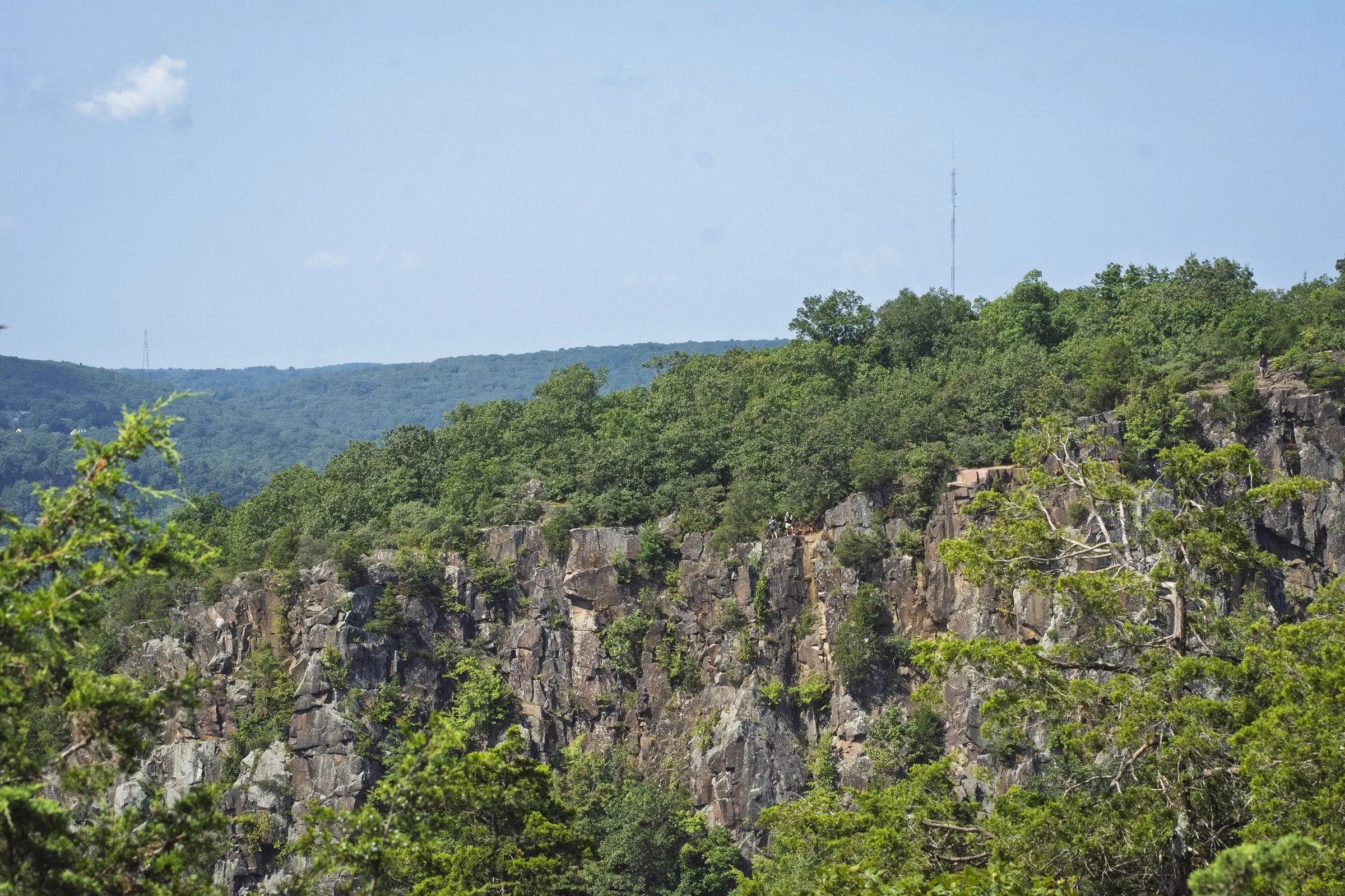 The traprock cliffs of Sleeping Giant in Hamden, with summer woods over the ridge