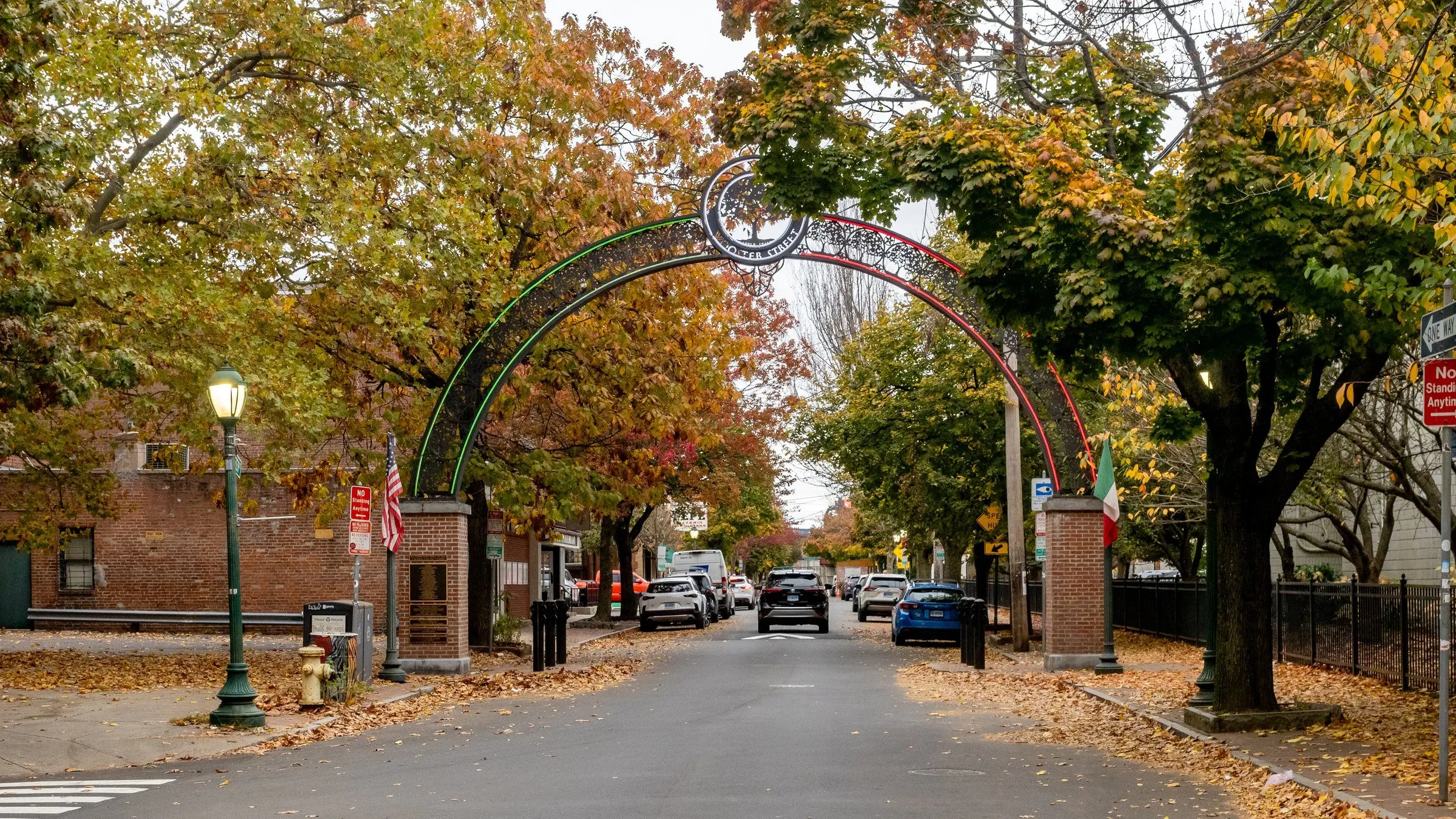 The ironwork arch over Wooster Street in New Haven, framed by autumn trees